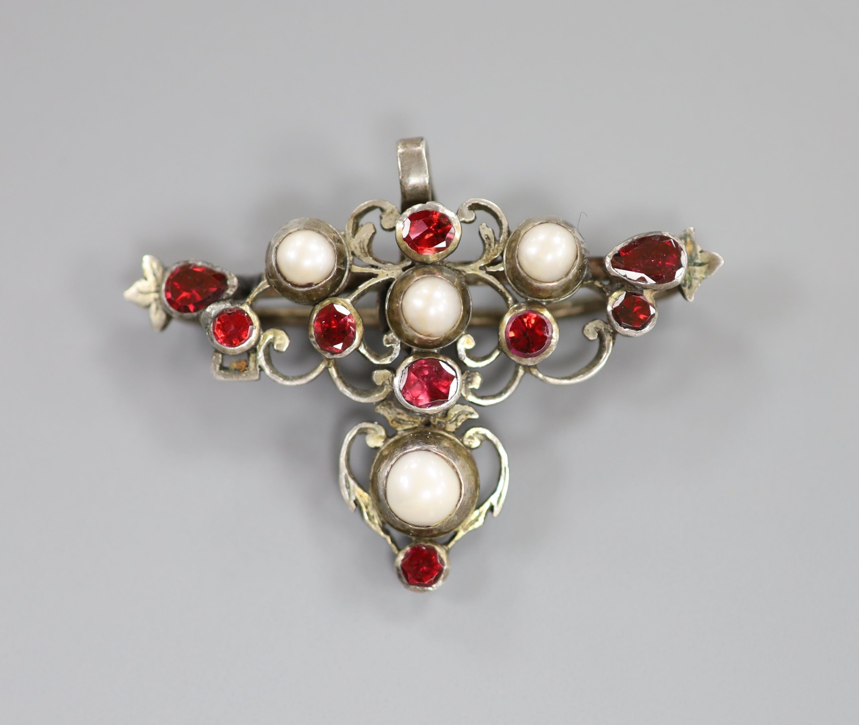 A 19th century white metal, garnet and pearl set pendant, width 45mm.